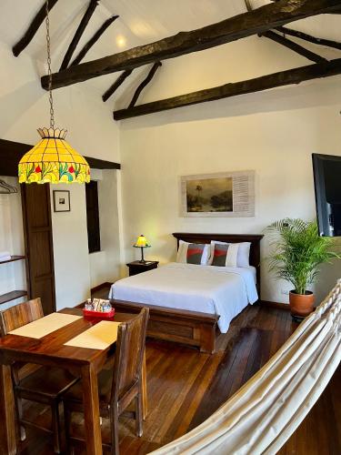 a bedroom with a bed and a hammock at Casa Aranjuez in Bogotá