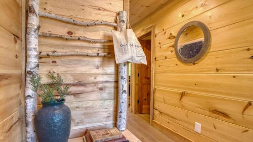 a log cabin hallway with a vase on the wall at Birch Lodge by AvantStay Indoor Pool Theater Game Room Stunning Views in Gatlinburg