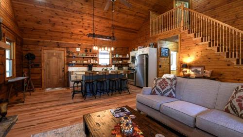 a living room and kitchen in a log cabin at Charming Blue Ridge Cabin Private Pond and Waterfall Deer Haven by AvantStay in Saluda