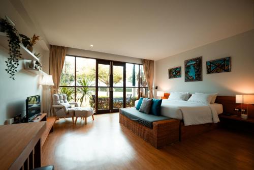 a bedroom with a bed and a couch in a room at Ma Villa Khao Yai in Mu Si