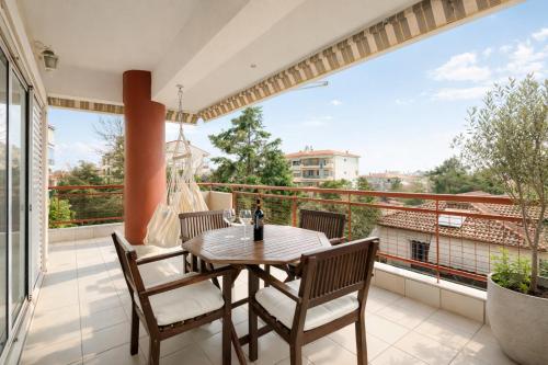 a patio with a table and chairs on a balcony at 3BR Suite 300mts from the Beach in Perea