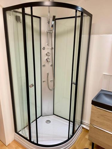 a shower with a glass enclosure in a bathroom at Maison 1925, Méricourt 62 in Méricourt