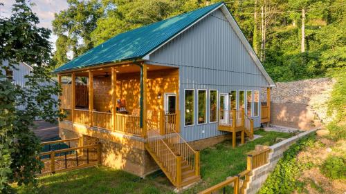 a tiny house with a blue roof at Cabin w Hot Tub Game Room Scenic Smoky Mountain Views Perfect by AvantStay in Gatlinburg