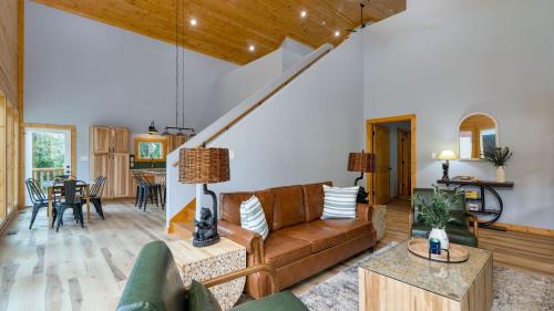 a living room with a couch and a table at Cabin w Hot Tub Game Room Scenic Smoky Mountain Views Perfect by AvantStay in Gatlinburg