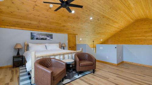 a bedroom with a bed and a wooden ceiling at Cabin w Hot Tub Game Room Scenic Smoky Mountain Views Perfect by AvantStay in Gatlinburg