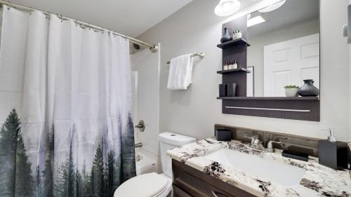 a bathroom with a sink and a shower curtain at Moshannon by AvantStay in Pocono Lake