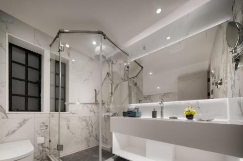 a white bathroom with a shower and a toilet at ANHE GARDEN HOTEL in Shanghai