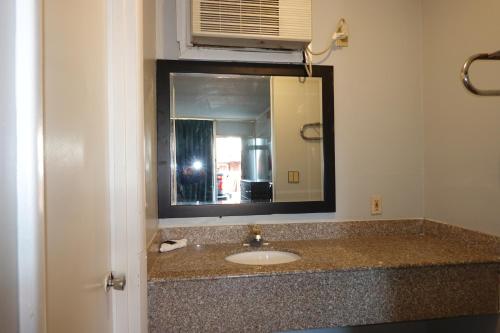 a bathroom with a sink and a mirror at Cascades Motel - Chattanooga in Chattanooga