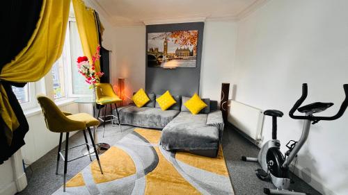 a living room with a couch and a bike at Spacious 3 Bedroom Entire Apartment Self Check in & Free Parking in Cowdenbeath