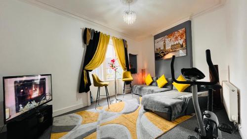 a living room with a couch and a tv at Spacious 3 Bedroom Entire Apartment Self Check in & Free Parking in Cowdenbeath