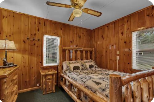 a bedroom with a bed and a ceiling fan at The Cozy Cub in Cross Lake