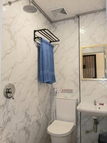 a bathroom with a toilet and a sink at Graha Citra Cirebon in Cirebon