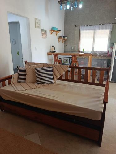 a large bed in a living room with at Casa de pedra in Prado