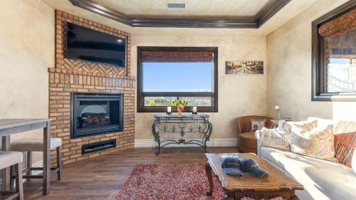 a living room with a couch and a fireplace at Soaking Tub Vineyard Views Wine Trail Access The Casita at Vines Estate by AvantStay in Temecula