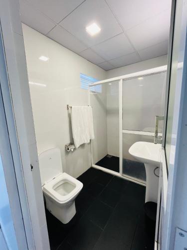 a bathroom with a toilet and a sink at Seaport Negombo in Negombo