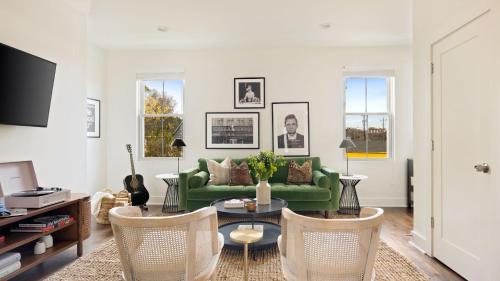 a living room with a green couch and chairs at Hart Suite 9 by AvantStay Gorgeous Town House w Modern Amenities in Nashville in Nashville