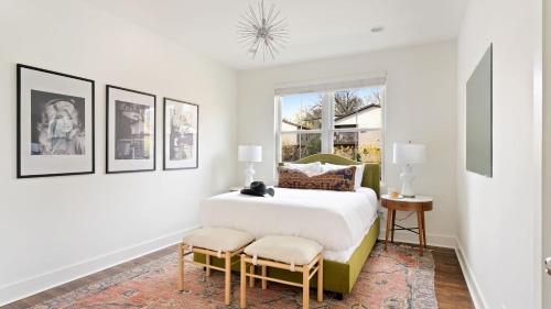 a white bedroom with a bed and two chairs at Hart Suite 9 by AvantStay Gorgeous Town House w Modern Amenities in Nashville in Nashville