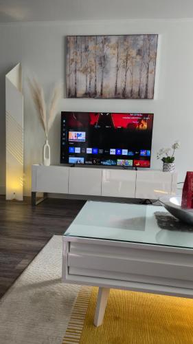 a living room with a large flat screen tv at Modern Coastal 2BR Retreat with Private Hot Tub in Vancouver BC in West Vancouver