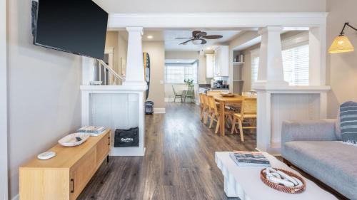 a living room with a couch and a dining room at Sea Sight by AvantStay Walk to Newport Beach in Newport Beach