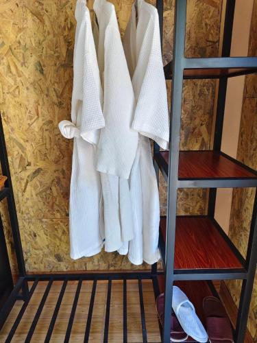 a rack of white towels hanging on a wall at Phu Siab Mhok@KhaoSok in Khao Sok National Park