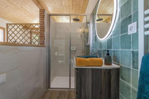 a bathroom with a shower and a sink at Le cabanon in Mauressac