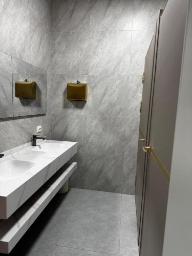 a bathroom with a white sink and a mirror at HOSTEL Q7 Almaty in Almaty