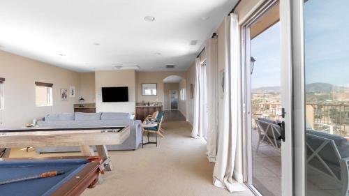 a living room with a couch and a pool table at Palazzo Del Sol By AvantStay Breathtaking Home w Mountain Views Hot Tub in Temecula