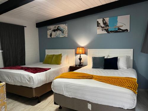 two beds sitting next to each other in a bedroom at Sequoia Village in Three Rivers