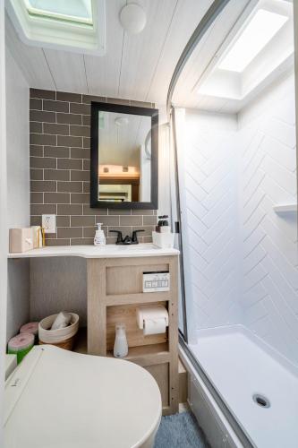 a bathroom with a tub and a toilet and a sink at Glamping Trailer Lanikai in Awaji