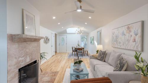 a living room with a couch and a fireplace at Conch Cottage by AvantStay Walk to Beach Deck Fireplace Outdoor Dining in Isle of Palms