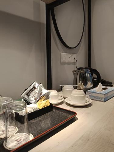 a table with plates and glasses and a mirror at Perkasa Hotel Mt Kinabalu in Kampong Kundassan