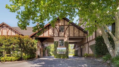 a large house with a gambrel roof at Peppers The Hills Lodge in Castle Hill