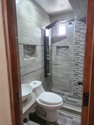 a bathroom with a toilet and a sink and a shower at Marito in Juliaca