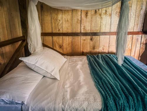 a bed in a wooden room with a canopy at Toucan Lodge Amazon Rainforest Retreat in Tarqui