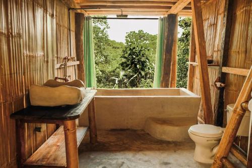 a bathroom with a tub and a sink and a toilet at Toucan Lodge Amazon Rainforest Retreat in Tarqui
