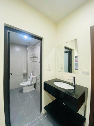 a bathroom with a sink and a toilet at CHIRU House Ninh Bình in Ninh Binh