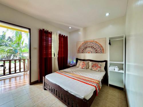 a bedroom with a bed and a large window at Lavajas Guest House in San Juan