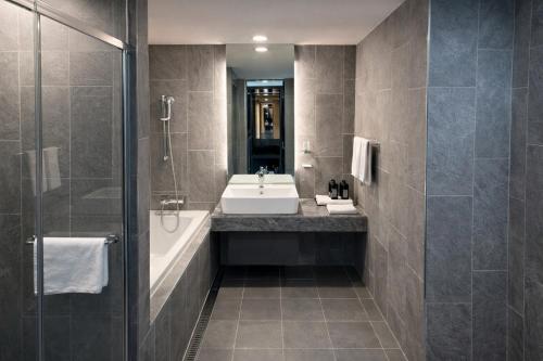 a bathroom with a sink and a tub and a shower at Sky Stay in Incheon