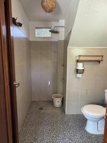 a bathroom with a toilet and a sink at Malinao Beachfront Studio, Starlink, Solar in General Luna