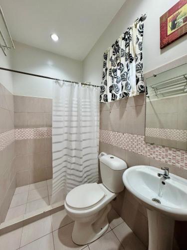 a bathroom with a toilet and a sink at Lavajas Guest House in San Juan