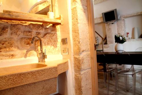 a kitchen with a sink and a living room with a piano at Dream Home in Ostuni
