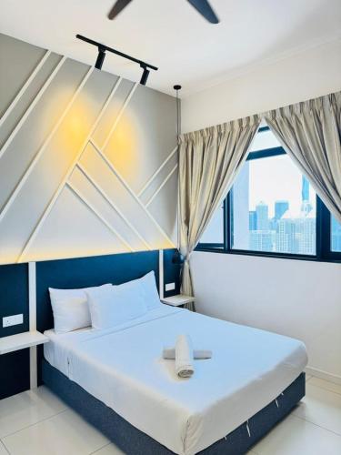 a bedroom with a large bed with a large window at Chamber Haven KL in Kuala Lumpur