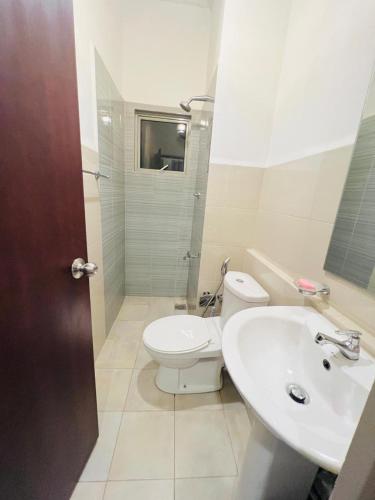 a bathroom with a toilet and a sink at Apartment For Rent in Ambulgama
