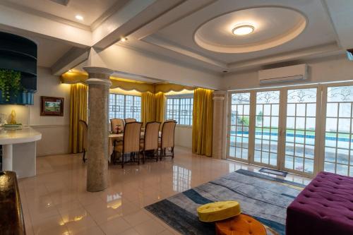 a large living room with a table and chairs at White House, Billiard, Private Pool, Prime Location in Angeles