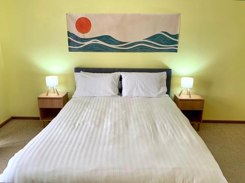 a bedroom with a large bed with two lamps on both sides at Blue Lagoon in American River
