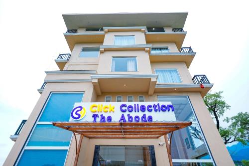 a tall building with a sign on it at Click Collection The Abode Dharamshala in Dharamshala