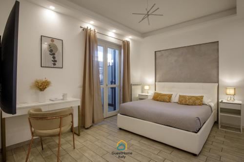 a bedroom with a bed and a table and a chair at Coho House Fiumicino in Fiumicino