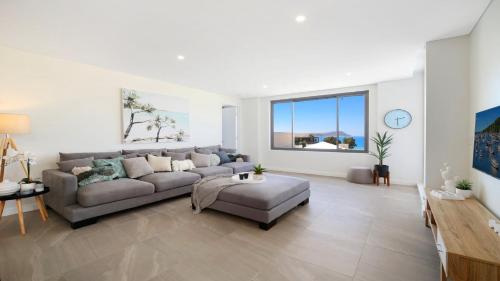 a living room with a couch and a table at Oceans Edge #7 Accom Holidays in Terrigal