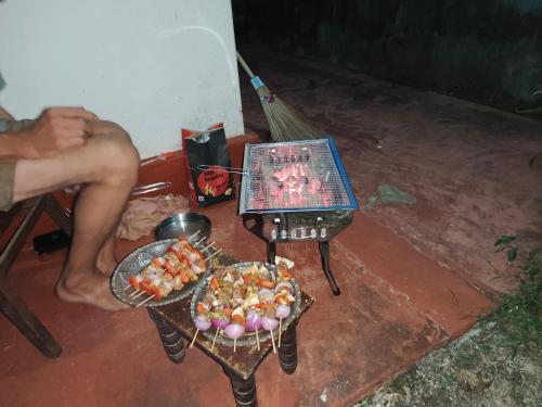 a grill with two plates of food on a table at Villa iSoNet in Weligama