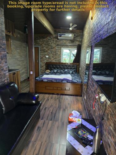 a room with a bed and a couch in it at Barla's Home Stay - Mini Studio Room in Shamshabad
